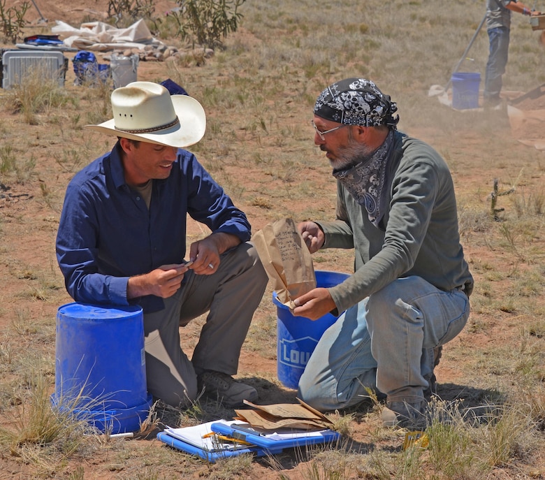 ABIQUIU LAKE, N.M. -- Dr. Sam Duwe (left) talks with undergraduate student Ray Frazier about his finds, June 21, 2016.