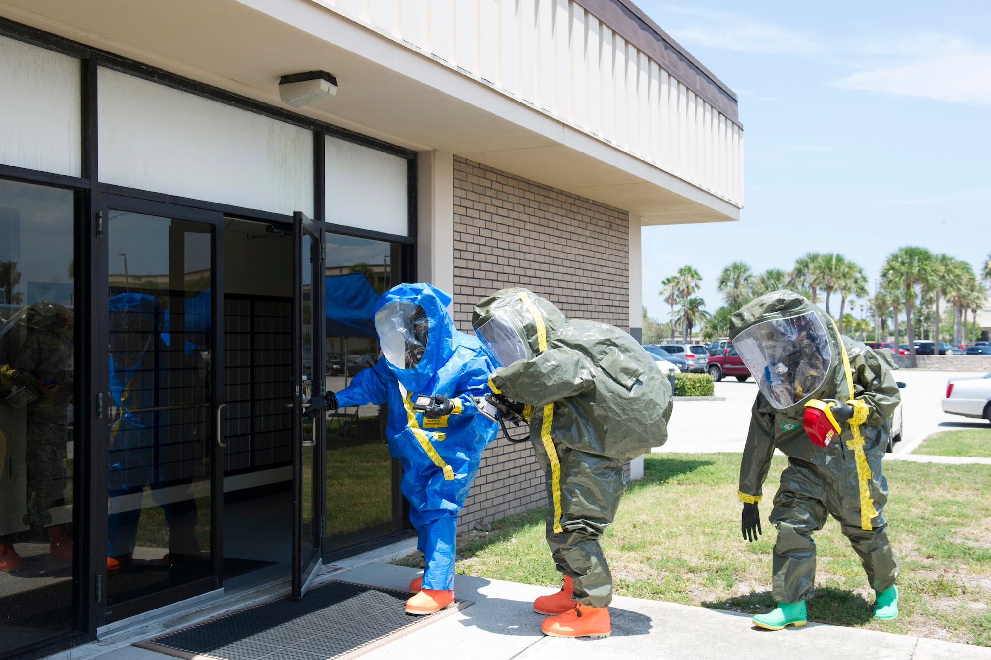 Members of 45th Medical Group's bioenvironmental flight suit up for training and respond to a simulated incident at the Patrick Air Force Base Post Office June 29, 2016. Their goal during the exercise was to train in identifying and evaluating environments that could harm personnel and families at the installation. In addition, they tested their response time and the safety equipment they are required to use when a HAZMAT threat exists. (U.S. Air Force photo by Matthew Jurgens/Released)