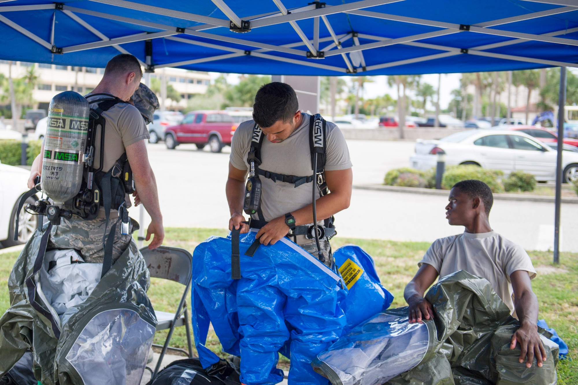 Members of 45th Medical Group's bioenvironmental flight suit up for training and respond to a simulated incident at the Patrick Air Force Base Post Office June 29, 2016. Their goal during the exercise was to train in identifying and evaluating environments that could harm personnel and families at the installation. In addition, they tested their response time and the safety equipment they are required to use when a HAZMAT threat exists. (U.S. Air Force photo by Matthew Jurgens/Released)
