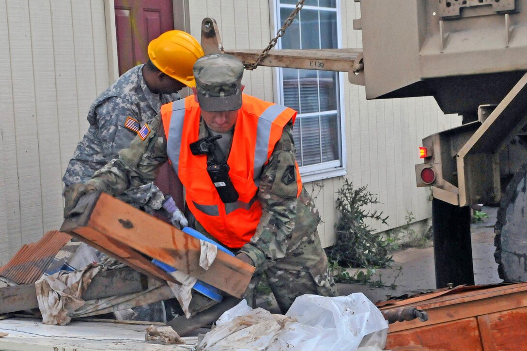 Soldiers help load debris onto a truck after flooding in Rainelle, W.Va., June 27, 2016. Army National Guard photo by Staff Sgt. Justin Hough