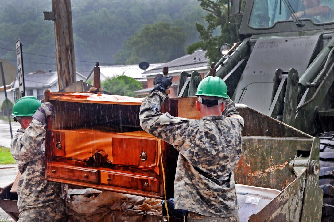 Soldiers help with the cleanup of flood debris during heavy rain in Rainelle, W.Va., June 27, 2016. Army National Guard photo by Staff Sgt. Justin Hough