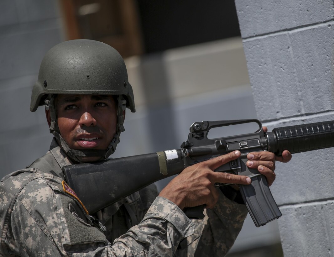 U.S. Army Reserve Staff Sgt. Mario Santos from the 404th Civil Affairs Battalion provides security for a police station that is under attack during Exercise Gridiron at Joint Base McGuire-Dix-Lakehurst, N.J., June 27, 2016. (U.S. Air National Guard photo by Tech. Sgt. Matt Hecht/Released)