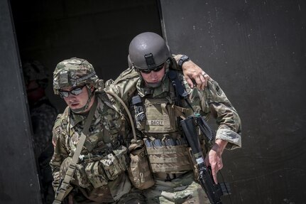 A U.S. Army Reserve Soldier from the 404th Civil Affairs Battalion assists a simulated casualty during Exercise Gridiron at Joint Base McGuire-Dix-Lakehurst, N.J., June 27, 2016. (U.S. Air National Guard photo by Tech. Sgt. Matt Hecht/Released)