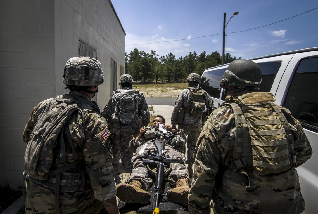 U.S. Army Reserve Soldiers from the 404th Civil Affairs Battalion move a simulated casualty during Exercise Gridiron at Joint Base McGuire-Dix-Lakehurst, N.J., June 27, 2016. (U.S. Air National Guard photo by Tech. Sgt. Matt Hecht/Released)