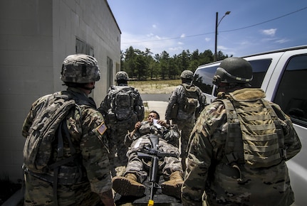 U.S. Army Reserve Soldiers from the 404th Civil Affairs Battalion move a simulated casualty during Exercise Gridiron at Joint Base McGuire-Dix-Lakehurst, N.J., June 27, 2016. (U.S. Air National Guard photo by Tech. Sgt. Matt Hecht/Released)