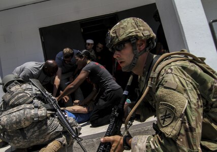 U.S. Army Reserve Soldiers from the 404th Civil Affairs Battalion assist simulated wounded civilians during Exercise Gridiron at Joint Base McGuire-Dix-Lakehurst, N.J., June 27, 2016. (U.S. Air National Guard photo by Tech. Sgt. Matt Hecht/Released)