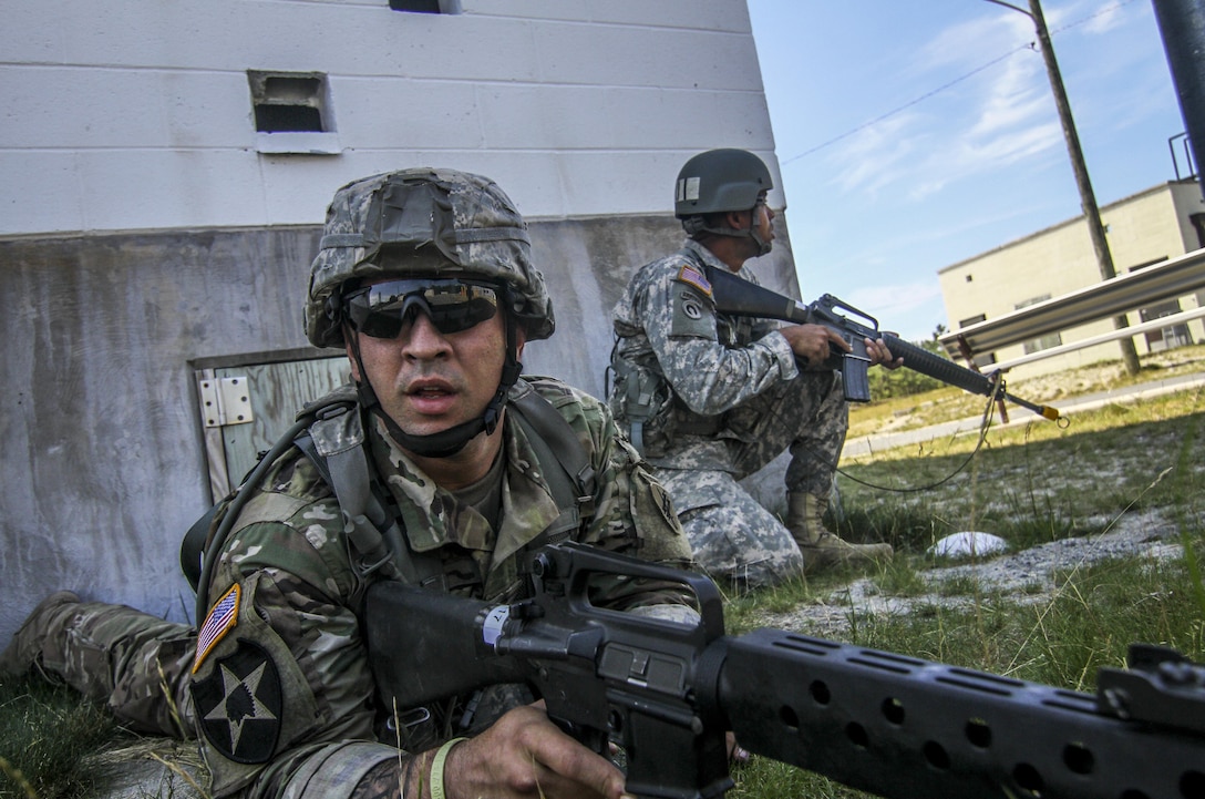 U.S. Army Reserve Soldiers from the 404th Civil Affairs Battalion take cover while under attack from opposing forces during Exercise Gridiron at Joint Base McGuire-Dix-Lakehurst, N.J., June 27, 2016. (U.S. Air National Guard photo by Tech. Sgt. Matt Hecht/Released)