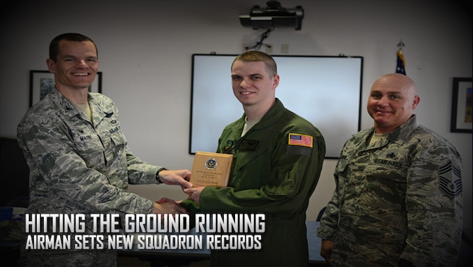 U.S. Air Force Airman 1st Class Connor Brush, 33rd Special Operations Squadron MQ-9 sensor operator, receives the Top III Hard Charger award from Col. Ben Maitre, 27th Special Operations Wing commander, and Chief Master Sgt. Scott Samdahl, 27th SOW command chief, May 12, 2016, at Cannon Air Force Base, N.M. Brush was nominated and selected for his unmatched professionalism, success in job performance, and for breaking various records within the squadron. (U.S. Air Force photo/Senior Airman Chip Slack) 
