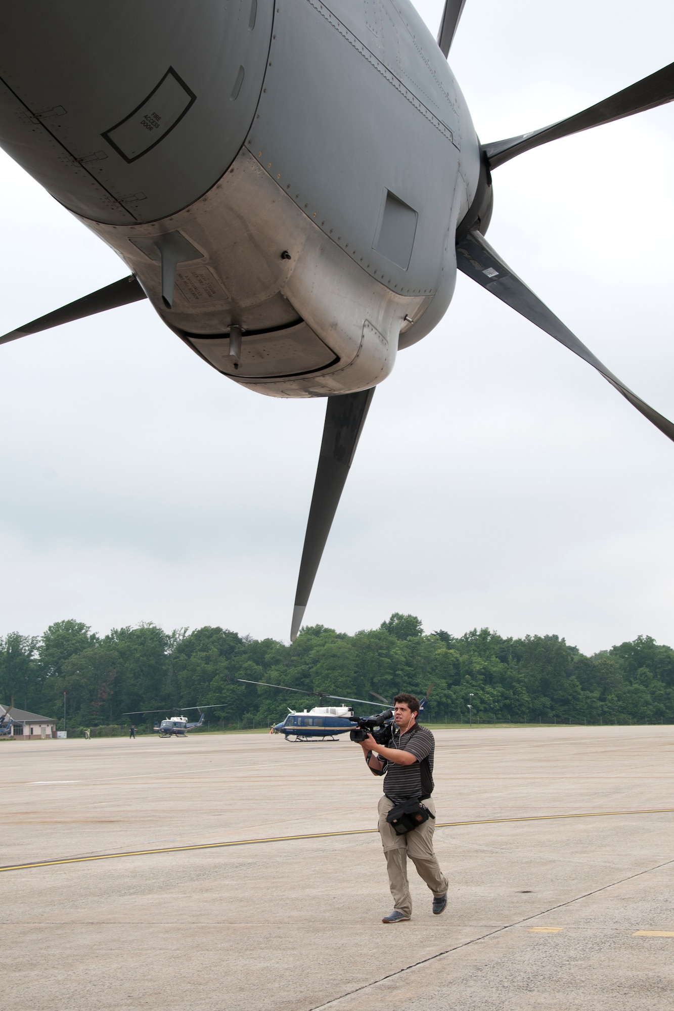 Daniel Wolfolk, Air Force Times videographer, captures footage of a C-130 Hercules on the Joint Base Andrews, Md., flight line June 28, 2016. In honor of the 100th anniversary of U.S. air reserve power, media members were invited to an event showcasing special missions conducted by C-130s in Air Force Reserve Command, to include weather surveillance, firefighting and aerial spraying. (U.S. Air Force photo/Staff Sgt. Kat Justen)