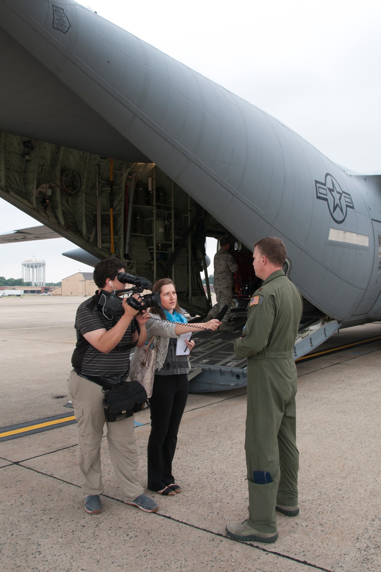 Journalists with the Air Force Times interview Maj. Kyle Larson, 53d Weather Reconnaissance Squadron “Hurricane Hunters” meteorologist, during a C-130 Hercules special-missions demonstration on the Joint Base Andrews, Md., flight line June 28, 2016. In honor of the 100th anniversary of U.S. air reserve power, media members were invited to the event, which highlighted C-130 missions to include weather surveillance, firefighting and aerial spraying. (U.S. Air Force photo/Staff Sgt. Kat Justen)