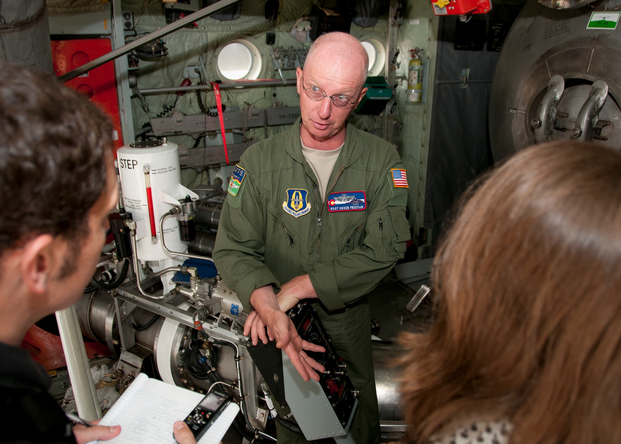 Master Sgt. Tom Freeman, 302nd Airlift Wing loadmaster (left), describes his unit’s specialized mission of aerial firefighting employing the U.S. Forest Service's Modular Airborne Fire Fighting Systems to a group of media members on the Joint Base Andrews, Md., flight line June 28, 2016. In honor of the 100th anniversary of U.S. air reserve power, media members were invited to an event showcasing special missions conducted by C-130s in Air Force Reserve Command, to include weather surveillance, firefighting and aerial spraying. (U.S. Air Force photo/Staff Sgt. Kat Justen)