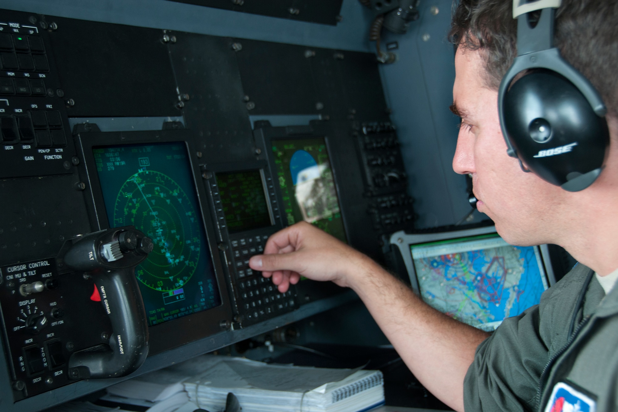 Major John Gharbi, 53d Weather Reconnaissance Squadron “Hurricane Hunters” navigator, checks the weather during a flight over Maryland June 28, 2016. As part of the 100th anniversary of air power in the U.S. military, members of the media were invited to fly with the Hurricane Hunters and learn about their weather surveillance mission. With ten deployable C-130s, the unit has the only routine aerial weather reconnaissance mission in the world. (U.S. Air Force photo/Staff Sgt. Kat Justen)