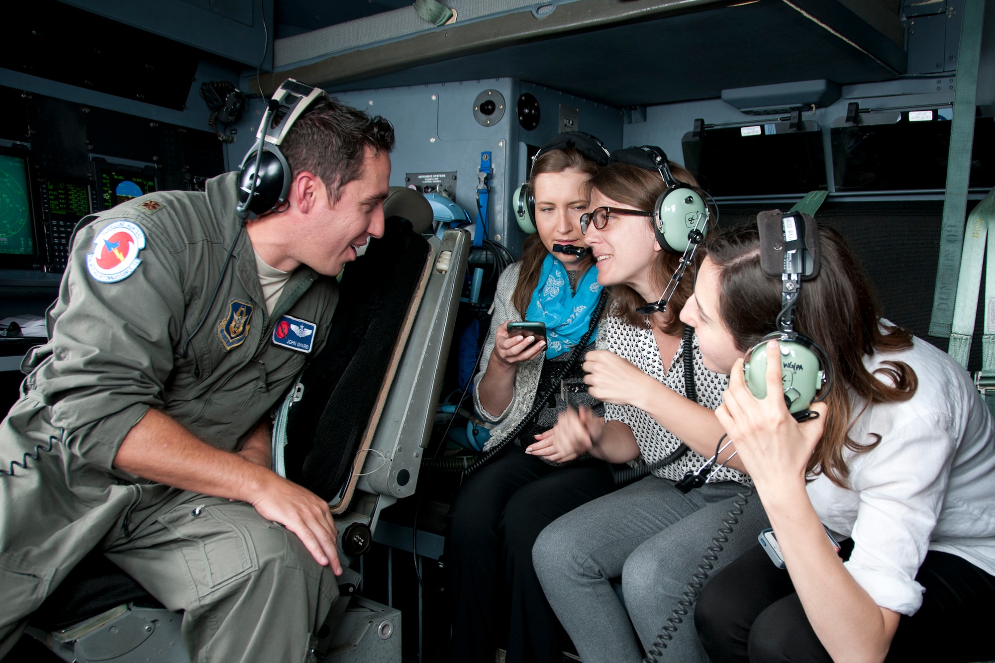 Major John Gharbi, 53d Weather Reconnaissance Squadron “Hurricane Hunters” navigator, speaks with members of the media during a flight over Maryland June 28, 2016. As part of the 100th anniversary of air power in the U.S. military, members of the media were invited to fly with the Hurricane Hunters and learn about their weather surveillance mission. With ten deployable C-130s, the unit has the only routine aerial weather reconnaissance mission in the world. (U.S. Air Force photo/Staff Sgt. Kat Justen)
