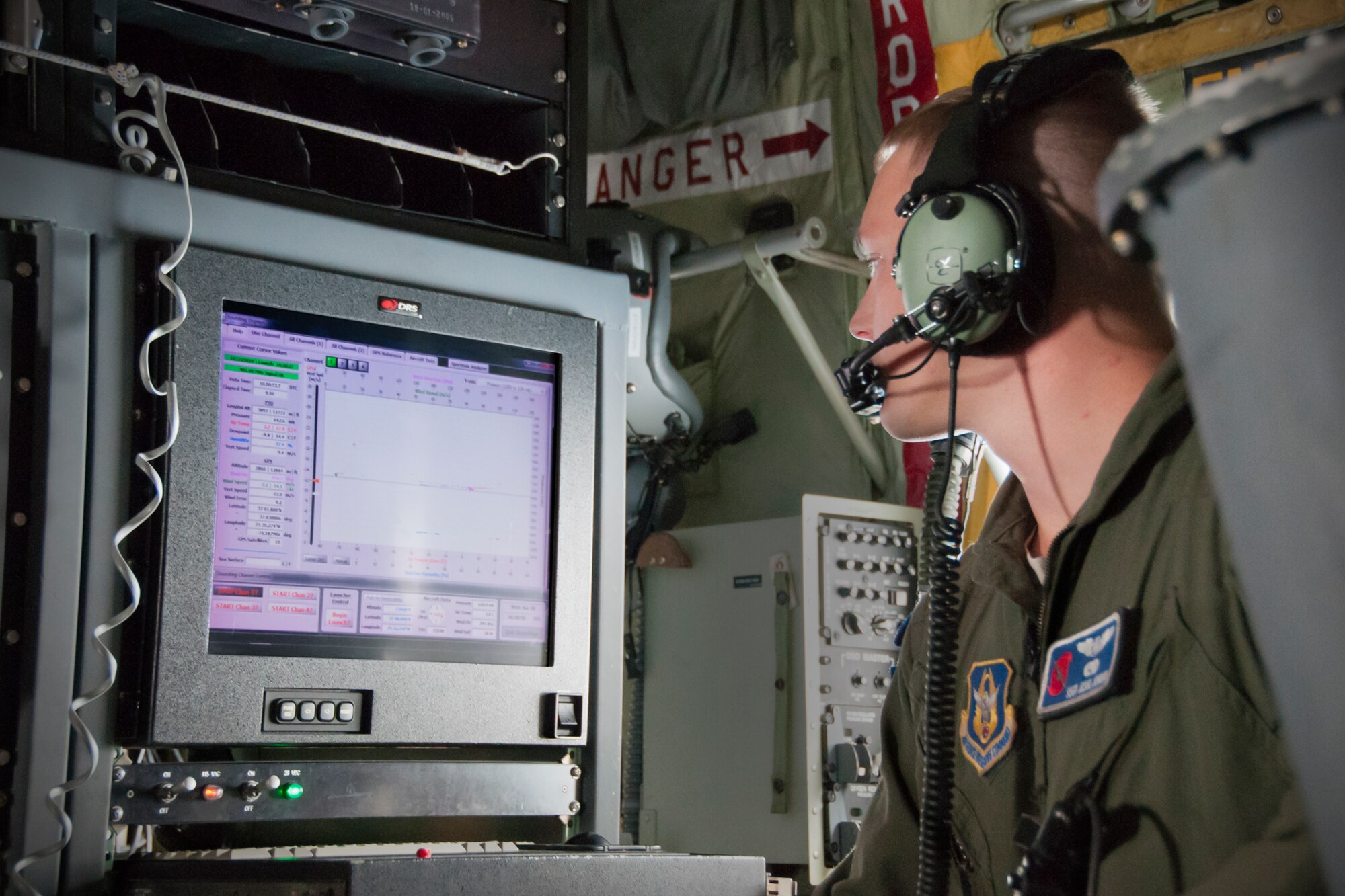 Staff Sgt. Jesse Jordan, 53d Weather Reconnaissance Squadron loadmaster, monitors weather data after deploying a dropsonde during a flight off of the east coast of the United States, June 28, 2016. A dropsonde is used by the Hurricane Hunters to collect temperature, humidity, wind speed and direction of weather systems. The information is then sent to the National Hurricane Center in Miami to monitor tropical storms. As part of the 100th anniversary of air power in the U.S. military, members of the media were invited to fly with the Hurricane Hunters and learn about their weather surveillance mission. (U.S. Air Force photo/Staff Sgt. Kat Justen)