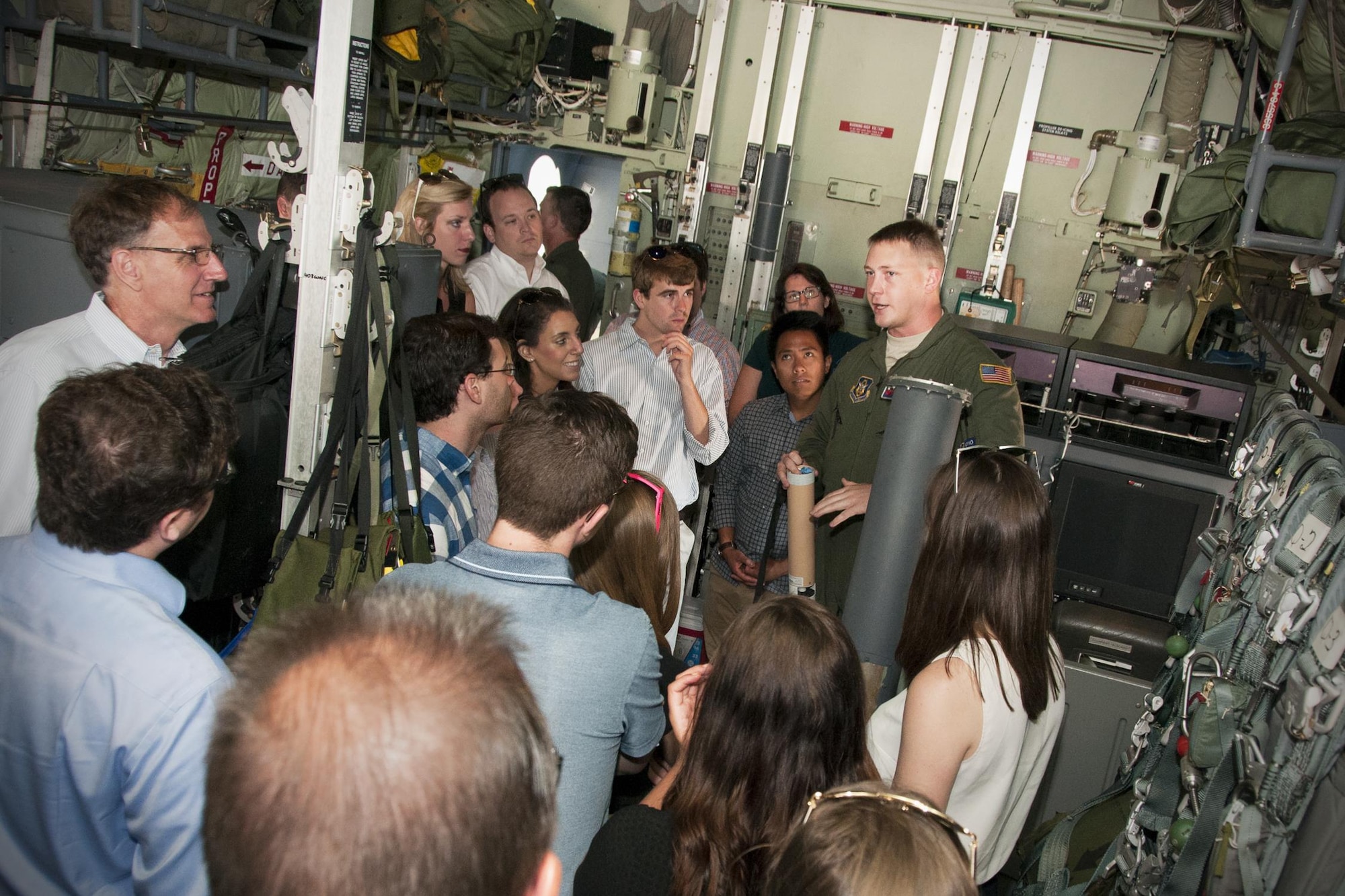 Staff Sgt. Jesse Jordan, 53d Weather Reconnaissance Squadron “Hurricane Hunters” loadmaster, discusses the use and function of a dropsonde tube to a group of congressional staffers inside a C-130 Hercules on the Joint Base Andrews, Md., flight line June 29, 2016. A dropsonde tube is used by the Hurricane Hunters to collect temperature, humidity, wind speed and direction of weather systems. The information is then sent to the National Hurricane Center in Miami to monitor tropical storms. As part of the 100th anniversary of air power in the U.S. military, members of the media were invited to fly with the Hurricane Hunters and learn about their weather surveillance mission. With ten deployable C-130s, the unit has the only routine aerial weather reconnaissance mission in the world. (U.S. Air Force photo/Staff Sgt. Kat Justen)
