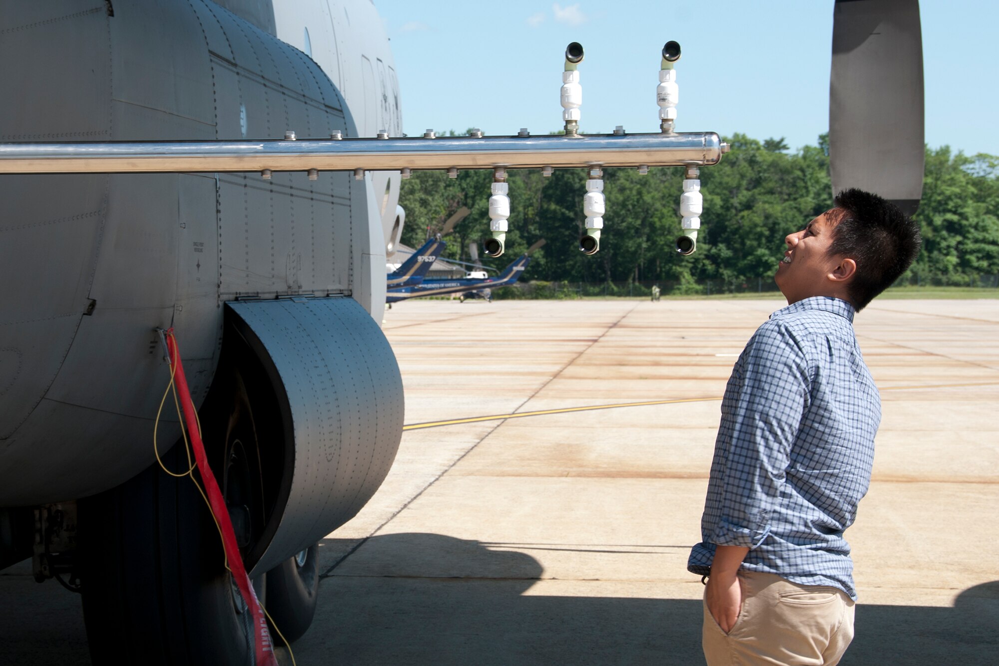 A congressional staff member examines the spray nozzles on a 757th Airlift Squadron C-130 Hercules on the Joint Base Andrews, Md., flight line June 29, 2016. In honor of the 100th anniversary of air reserve power, members of the 53d WRS visited Andrews to participate in a C-130 Hercules special-missions demonstration. The 757th AS has the specialized mission of aerial spray capability to control disease-carrying insects, pest insects, undesirable vegetation and to disperse oil spills in large bodies of water. (U.S. Air Force photo/Staff Sgt. Kat Justen) 