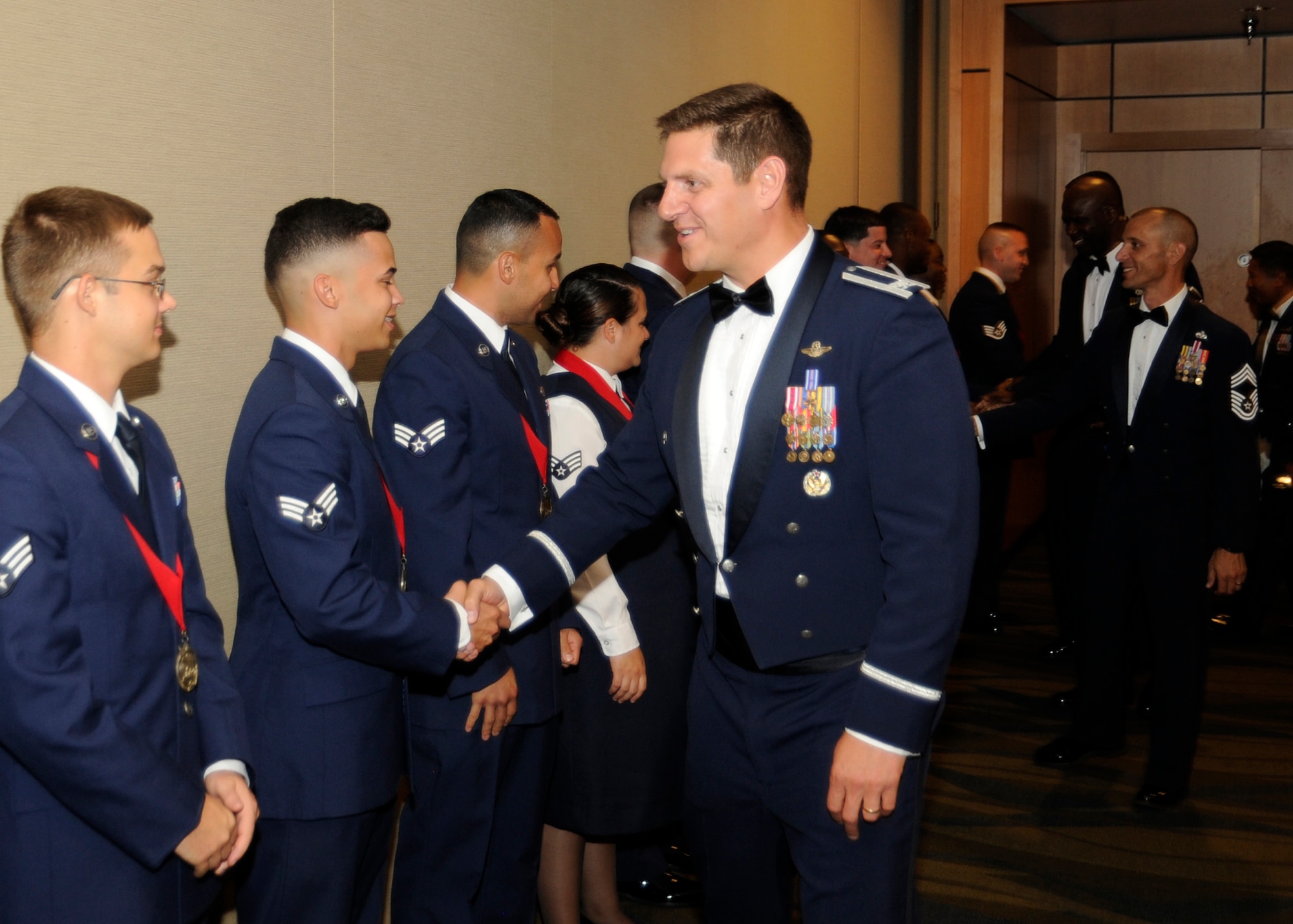 Colonel Joseph Kunkel, 325th Fighter Wing vice commander, gives congratulatory handshakes to graduates of Airman Leadership School Class 16-5 at the Horizons Club June 23, 2016. At ALS, Airmen who are soon-to-be supervisors, learn the fundamentals of leadership through four blocks of instruction: leadership, human relations, communication, and profession of arms. The five-week course encompasses 192 hours of instruction. The schoolhouse graduates approximately seven classes per year with each class consisting of approximately 40 Airmen. (U.S. Air Force photo by Senior Airman Solomon Cook/Released) 