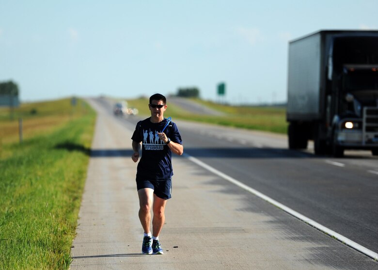 Staff Sgt. Brendan Brustad, 319th Air Base Wing assistant to the wing executive officer, runs down Interstate 29 in Grand Forks, N.D.  June 29, 2016. Brustad ran from Winnipeg, Canada to Grand Forks Air Force Base, N.D. as part of a month-long run for post-traumatic stress disorder awareness that totaled 694 miles. (U.S. Air Force photo by Senior Airman Ryan Sparks/Released)