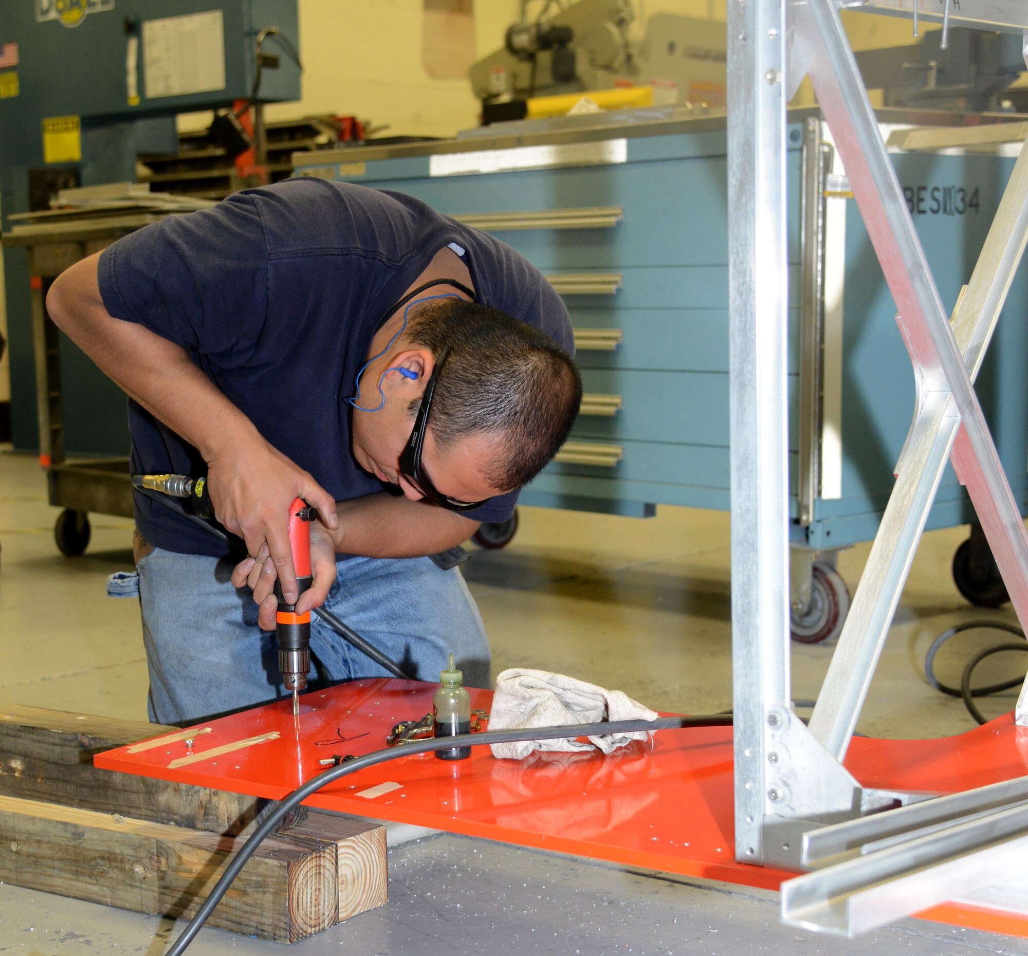 Rafiq Viray, a model maker with the 412th Maintenance Squadron’s instrumentation division, threads mount holes in the base of the flight test engineer workstation scheduled to be used for KC-46A Pegasus testing. The workstation was designed in modules for ease of construction, installation and reconfiguration. (U.S. Air Force photo/Christopher Ball)