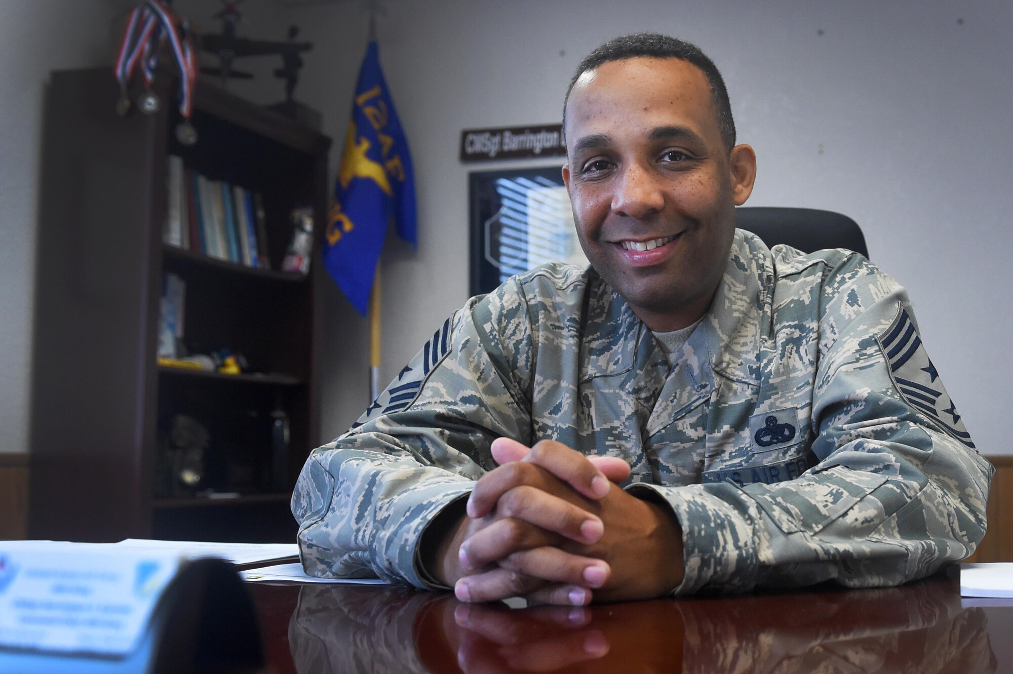 Chief Master Sgt. Barrington Bartlett, the 49th Wing command chief, poses for a portrait in his office at Holloman Air Force Base, N.M., on June 27. Bartlett, who formerly served as the 56th Maintenance Group superintendent at Luke Air Force Base, Ariz., is Holloman’s newest command chief. (U.S. Air Force photo by Staff Sgt. Eboni Prince)