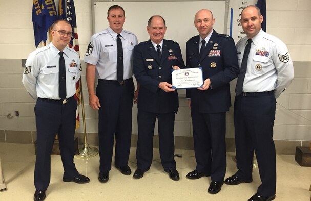 An Air Force Recruiting Service certificate of appreciation is presented to the Junior ROTC instructors at Bell County High School in Pineville, Kentucky. From left are Tech. Sgt. Jason Miller, 332nd Recruiting Squadron; retired Air Force Master Sgt. James Browning and retired Air Force Lt. Col. Barry Tanner, JROTC instructors; and Tech. Sgt. Casey Davis, 332nd RCS. (U.S. Air Force photo/Senior Master Sgt. John Roy)

