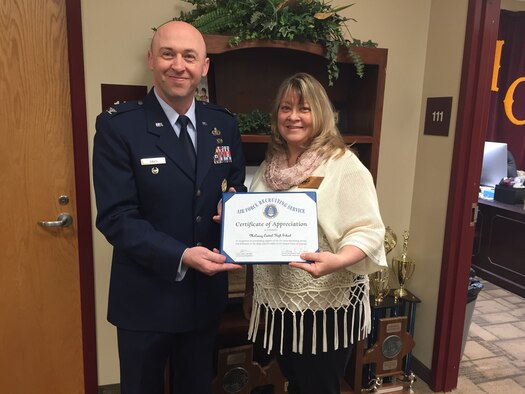 Col. Danny Davis presents an Air Force Recruiting Service certificate of appreciation to Sharon Privett, principal of McCreary Central High School. Davis graduated from the school in 1989. (U.S. Air Force photo/Senior Master Sgt. John Roy)

