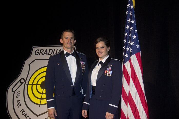 Lt. Col. Scott Mills, U.S. Air Force Weapons School, 66th Weapons Squadron commander and Capt. Jessica Wyble, 66th WPS A-10 Thunderbolt II pilot, pose at the USAFWS graduation ceremony, Las Vegas, June 25, 2016.  Wyble is the first woman to successfully complete the USAFWS graduate-level A-10 weapons instructor course that provides the world's most advanced training in weapons and tactics employment.