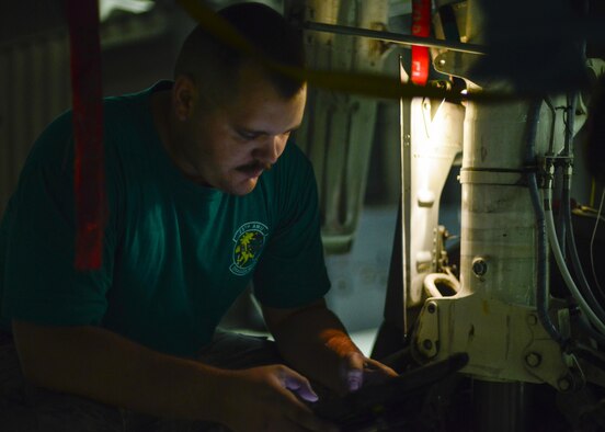 Senior Airman Jarred Sozzi, 25th Aircraft Maintenance Unit electronic and environmental systems technician, reads through a technical order while placing a weight-on-wheel harness and switch on an A-10 Thunderbolt II at Osan Air Base, Republic of Korea, June 24, 2016. Sozzi grew up admiring the A-10 before joining the Air Force, ultimately choosing to perform maintenance on his favorite aircraft for a living. (U.S. Air Force photo by Senior Airman Victor J. Caputo/Released)