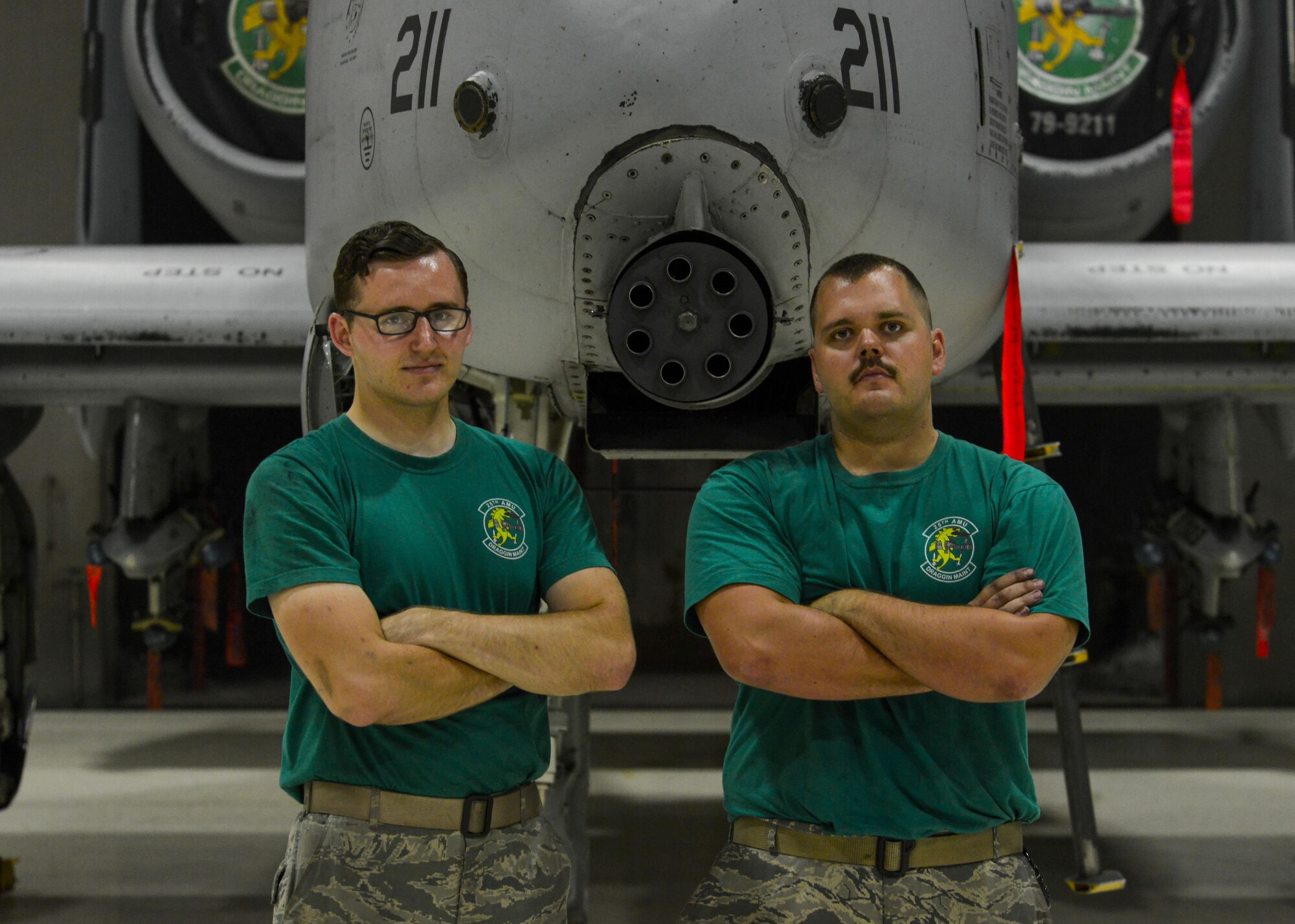 Senior Airmen Jonathan Wirkkala, left, 25th Aircraft Maintenance Unit avionics systems technician, and Jarred Sozzi, 25th Aircraft Maintenance Unit electronic and environmental systems technician, pose in front of an A-10 Thunderbolt II at Osan Air Base, Republic of Korea, June 24, 2016. The two maintenance Airmen were life-long fans of the A-10, leading them to choose careers working on the aircraft after enlisting in the Air Force. (U.S. Air Force photo by Senior Airman Victor J. Caputo/Released)