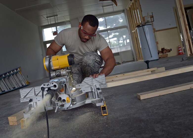 U.S. Air Force Airman 1st Class Victor Blake, a structural journeyman with the 35th Civil Engineer Squadron, cuts blocks of wood during the renovation of the Arts and Crafts Center at Misawa Air Base, Japan, June 27, 2016. Blake and other structures Airmen have been working on this project to combine the building and its annex since April 2016. The finished product will showcase a larger work center to accommodate both facilities. (U.S. Air Force photo by Senior Airman Deana Heitzman)