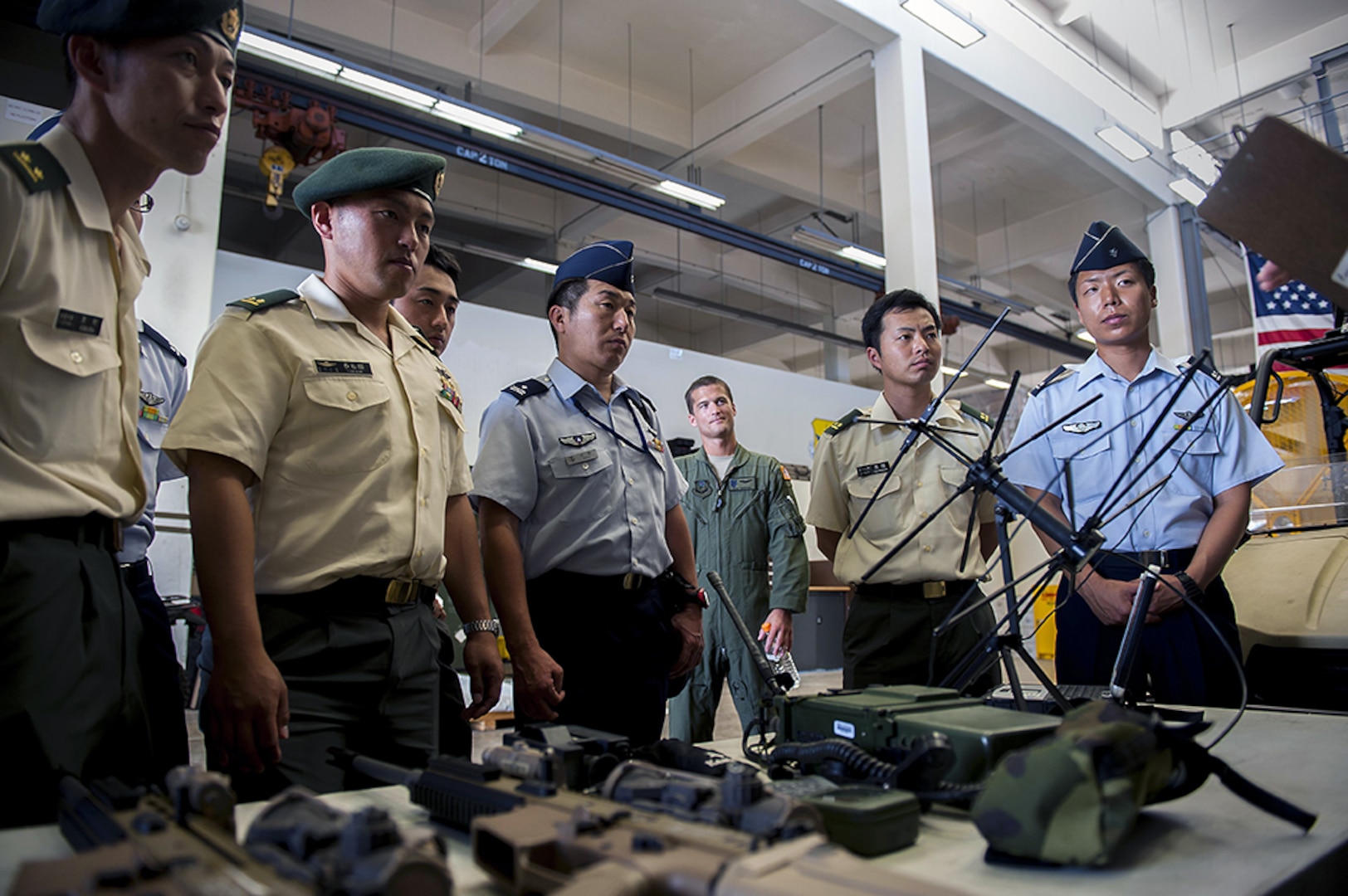 Japan Air Self-Defense Force and Japan Ground Self-Defense Force members attending the 52nd Joint Tactical Operations Course get a briefing about some of the equipment the 320th Special Tactics Squadron uses during a tour of the 353rd Special Operations Squadron June 21, 2016, at Kadena Air Base, Japan. Members of JGSDF and JASDF bond with their U.S. Air Force counterparts as they discuss the similarities and differences in the equipment they use and the missions they train for. 