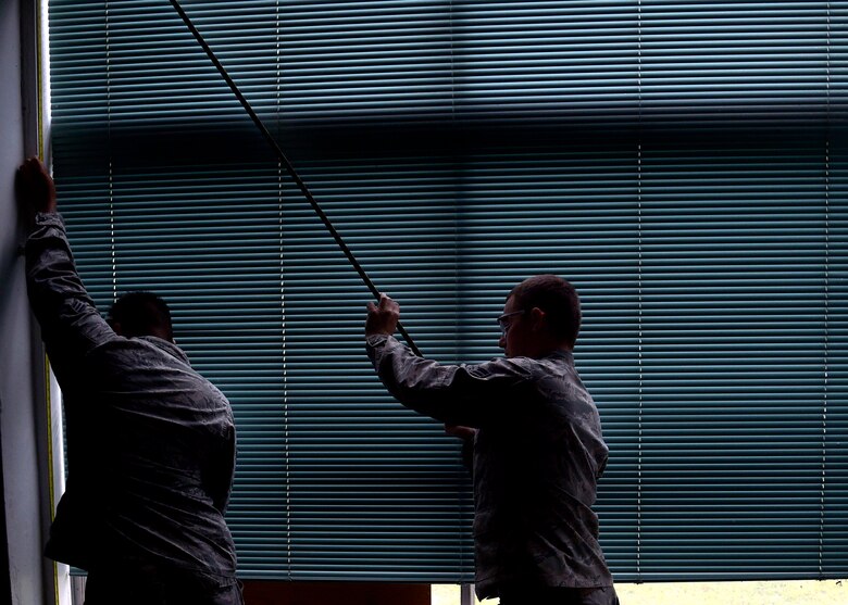 U.S. Air Force Senior Airman Eric Garcia and Airman 1st Class Alexander Crutchfield, structural journeymen with the 35th Civil Engineer Squadron, measure a window frame during the renovation of the Arts and Craft Center at Misawa Air Base, Japan, June 24, 2016. Structures Airmen follow blueprints and other plans to construct, maintain, plan and repair wooden, masonry and concrete buildings and structures. They also ensure each project abides by environmental regulations. (U.S. Air Force photo by Senior Airman Deana Heitzman)