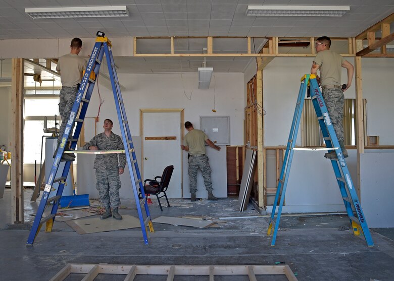 U.S. Air Force Airmen with the 35th Civil Engineer Squadron structures shop install drywall inside the Arts and Crafts Center at Misawa Air Base, Japan, June 27, 2016. Recently, the structures team completed a hangar renovation to house four RQ-4 Global Hawk aircraft and constructed a 42-point firing range to better facilitate M-4 rifle and M-9 pistol qualifications. (U.S. Air Force photo by Senior Airman Deana Heitzman)