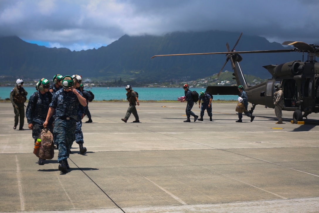 Sailors with Helicopter Maritime Strike Squadron 37 dismount an aircraft after landing aboard Marine Corps Air Station Kaneohe Bay, June 27, 2016.  The "Easyriders’" Detachment 7 embarked the USS Chung-Hoon on January 27, 2016, in support of multi-national exercises and presence operations in the Indo-Asia Pacific. While on their 6-month deployment, the crew of 300 Sailors conducted various theater security operations and goodwill activities with partner nations. (U.S. Marine Corps photo by Cpl. Zachary Orr)
