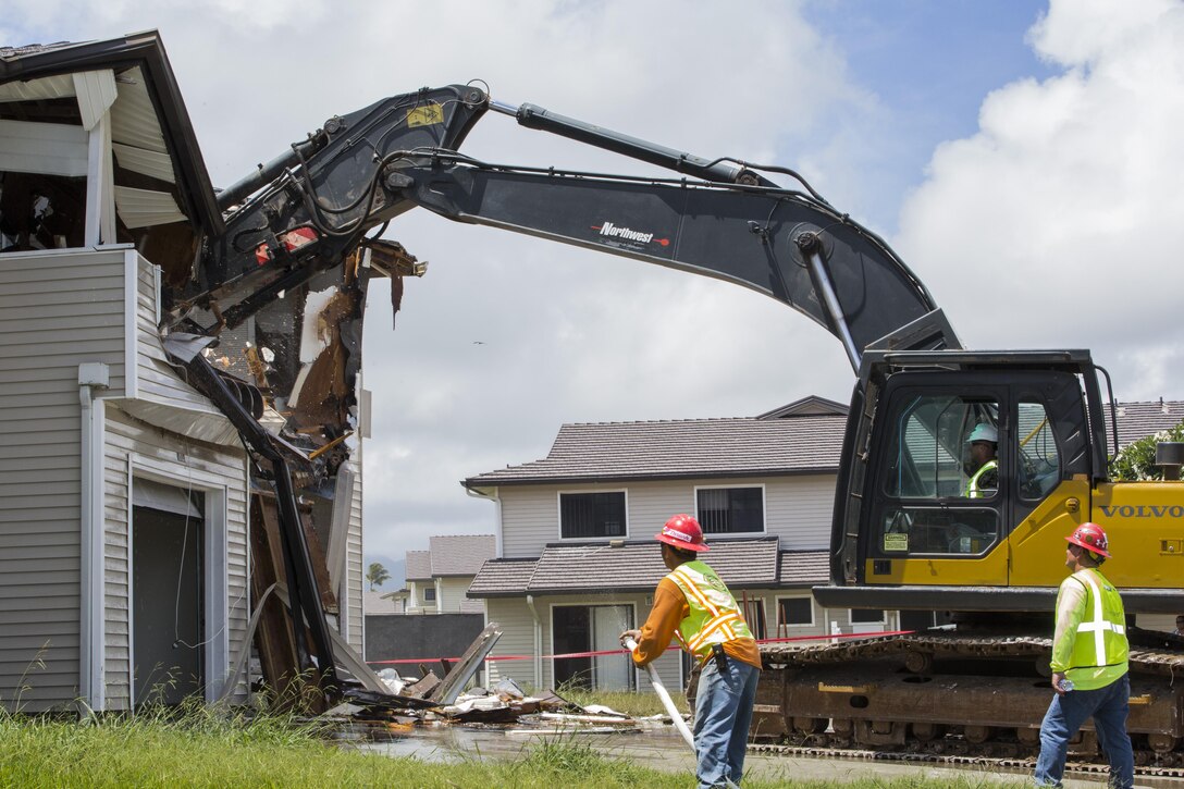 MARINE CORPS BASE HAWAII – Col. Killeen, the commanding officer for Marine Corps Base Hawaii, and a Mundelein, Ill., native, is given the opportunity to tear down a home, as part of a blessing and demolition ceremony, officially starting the construction project aboard MCB Hawaii, June 22, 2016. This ceremony was the official start of Phase 6, a multi-phased construction partnership where 276 homes will be torn down and rebuilt, which is part of the last major housing redevelopment on the Mokapu peninsula. The demolition site, workers and land were blessed by a Hawaiian minister, as per Hawaiian tradition for construction projects. This project will be the central community on the base, which will also include a pavilion, two large playgrounds and a basketball court. (U.S. Marine Corps Photo by Lance Cpl. Jesus Sepulveda Torres)