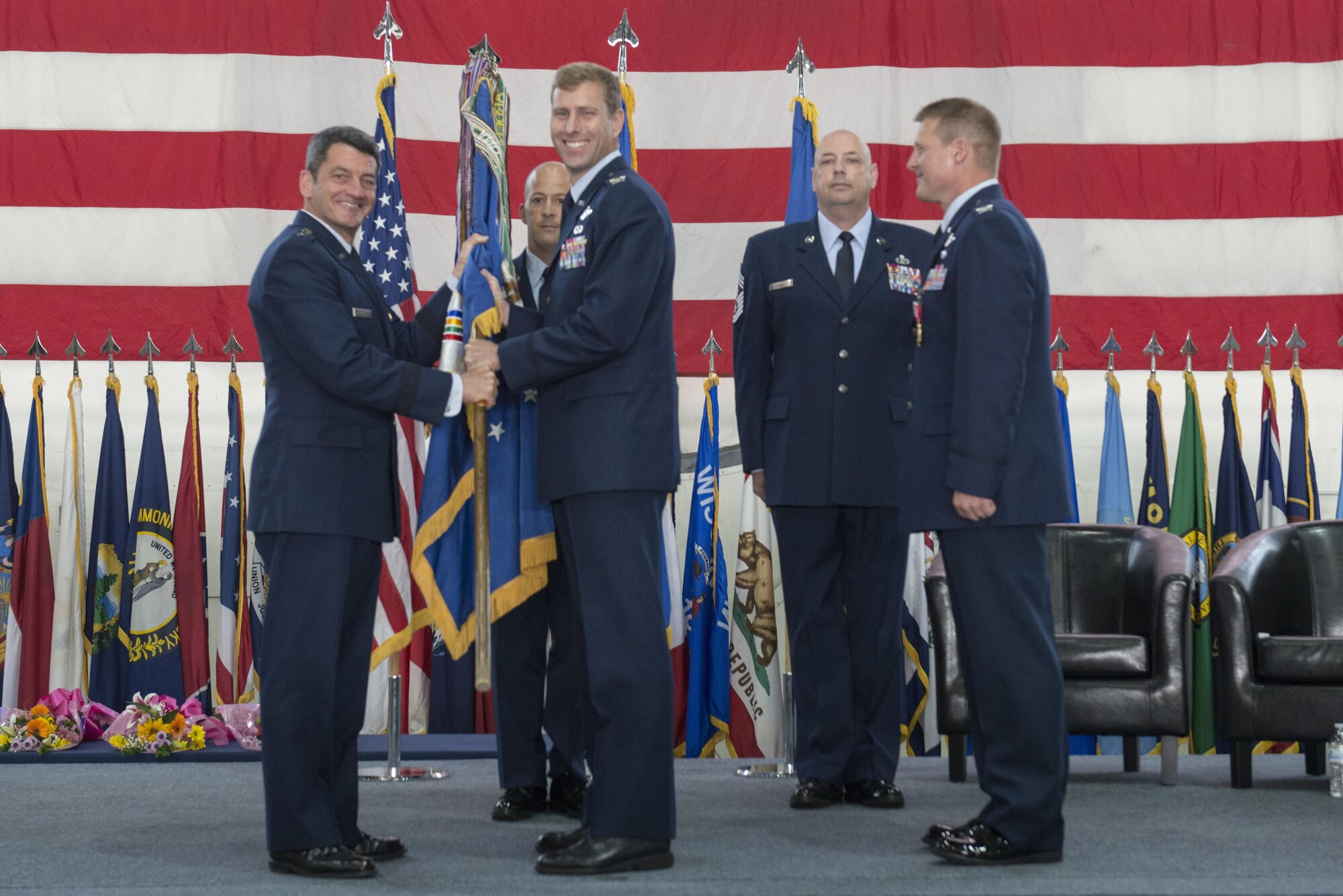 U.S. Air Force Lt. Gen. Russell Handy, the Eleventh Air Force commander, passes the 354th Fighter Wing (FW) guidon to Col. David Mineau, the new 354th FW commander, June 29, 2016, at Eielson Air Force Base, Alaska. Col. Michael Winkler, the outgoing wing commander, will move on to Yokota Air Base, Japan, to serve as the 5th Air Force vice commander. (U.S. Air Force photo by Staff Sgt. Ashley Nicole Taylor/Released)
