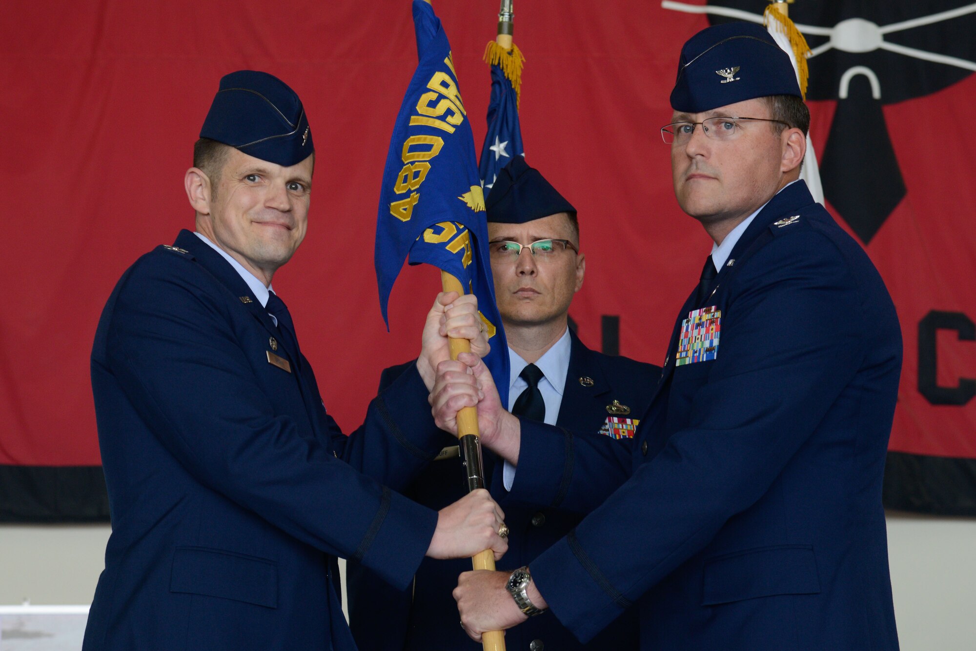 Col. James Brown, 408th Intelligence, Surveillance and Reconnaissance Wing commander, and Col. James Mock, 694th ISR Group commander, pose for a photo during a change of command ceremony at Osan Air Base, Republic of Korea, June 30, 2016. Mock returned to Osan after 30 years to command the 694th ISRG. (U.S. Air Force photo by Senior Airman Dillian Bamman/Released)