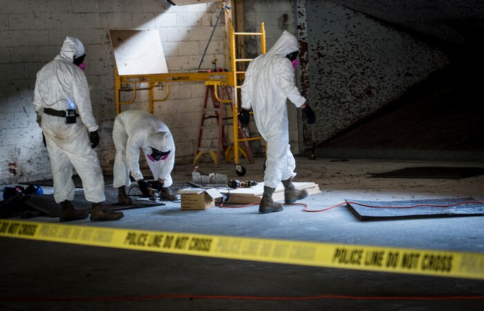 628th Civil Engineer Squadron utility and structures Airmen conduct repairs while wearing respirators and protective gear on the small arms firing range at Joint Base Charleston, S.C., June 24, 2016.  The repairs were needed because the damaged baffles were preventing the use of 12 of 20 firing lanes. The re-faced baffles and repaired backstop will allow the range to be operated within safety guidelines, providing a safe environment for JB Charleston personnel to qualify on their shooting skills.  (U.S. Air Force photo by Staff Sgt. Andrea Salazar/Released)