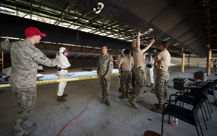 628th Security Forces Squadron, Civil Engineer Squadron and Aerospace Bioenvironmental Squadron personnel discuss repair plans for the small arms firing range June 24, 2016 at Joint Base Charleston, S.C. Airmen from all three squadrons worked together to repair the wooden baffles on the range. Repairing the baffles is crucial for safety because they prevent high shots from leaving the area. The existing baffles were bullet riddled, warped and rotten. The bullet holes and other damage were causing weak spots, which could allow bullets to fly outside the range. (U.S. Air Force photo by Staff Sgt. Andrea Salazar/Released)