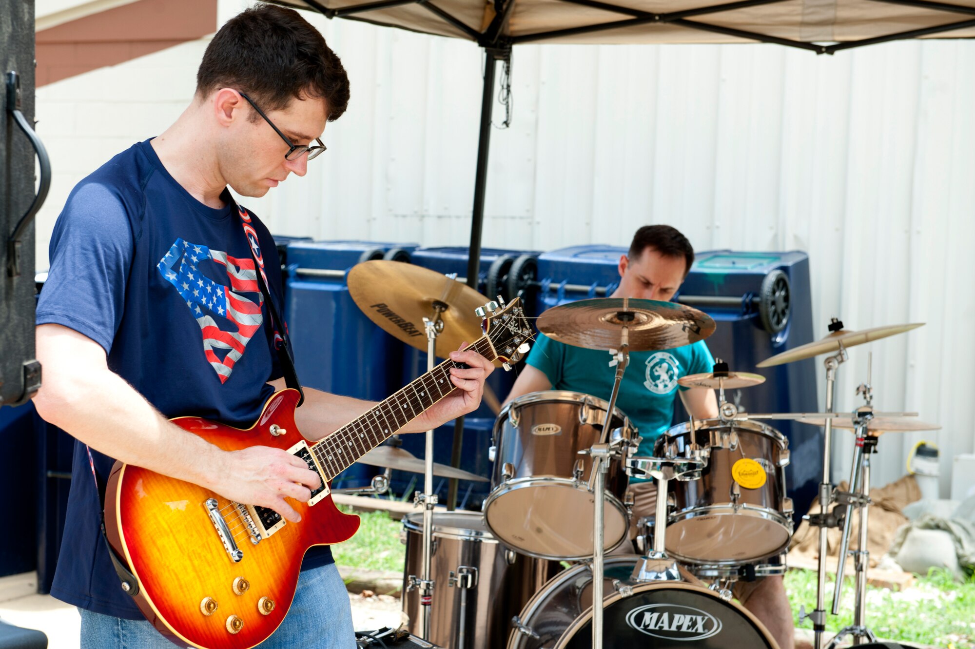 Members of “Collateral Damage,” a local rock ‘n’ roll band comprised of U.S. Air Force Airmen, perform during the 363rd Intelligence Support Squadron anniversary celebration at Langley Air Force Base, Va., June 24, 2016. Since activated in 2015, the squadron garnered numerous accomplishments including excellent ratings on multiple inspections. (U.S. Air Force photo by Staff Sgt. R. Alex Durbin)