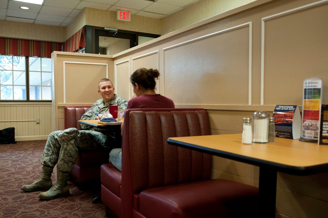 Master Sgt. Philip May, 633rd Medical Group first sergeant, speaks to an U.S. Air Force Airman during a Random Acts of Kindness campaign at the Dining Facility at Langley Air Force Base, Va., June 21, 2016. Throughout 2015, the First Sergeants Council distributed more than $52,000 in donations to Langley community members. (U.S. Air Force photo by Staff Sgt. R. Alex Durbin)