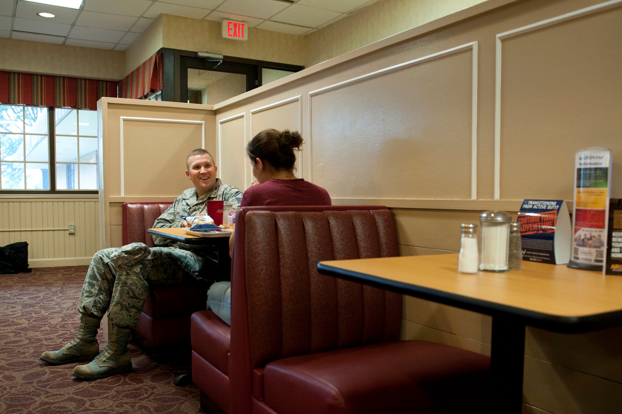 Master Sgt. Philip May, 633rd Medical Group first sergeant, speaks to an U.S. Air Force Airman during a Random Acts of Kindness campaign at the Dining Facility at Langley Air Force Base, Va., June 21, 2016. Throughout 2015, the First Sergeants Council distributed more than $52,000 in donations to Langley community members. (U.S. Air Force photo by Staff Sgt. R. Alex Durbin)