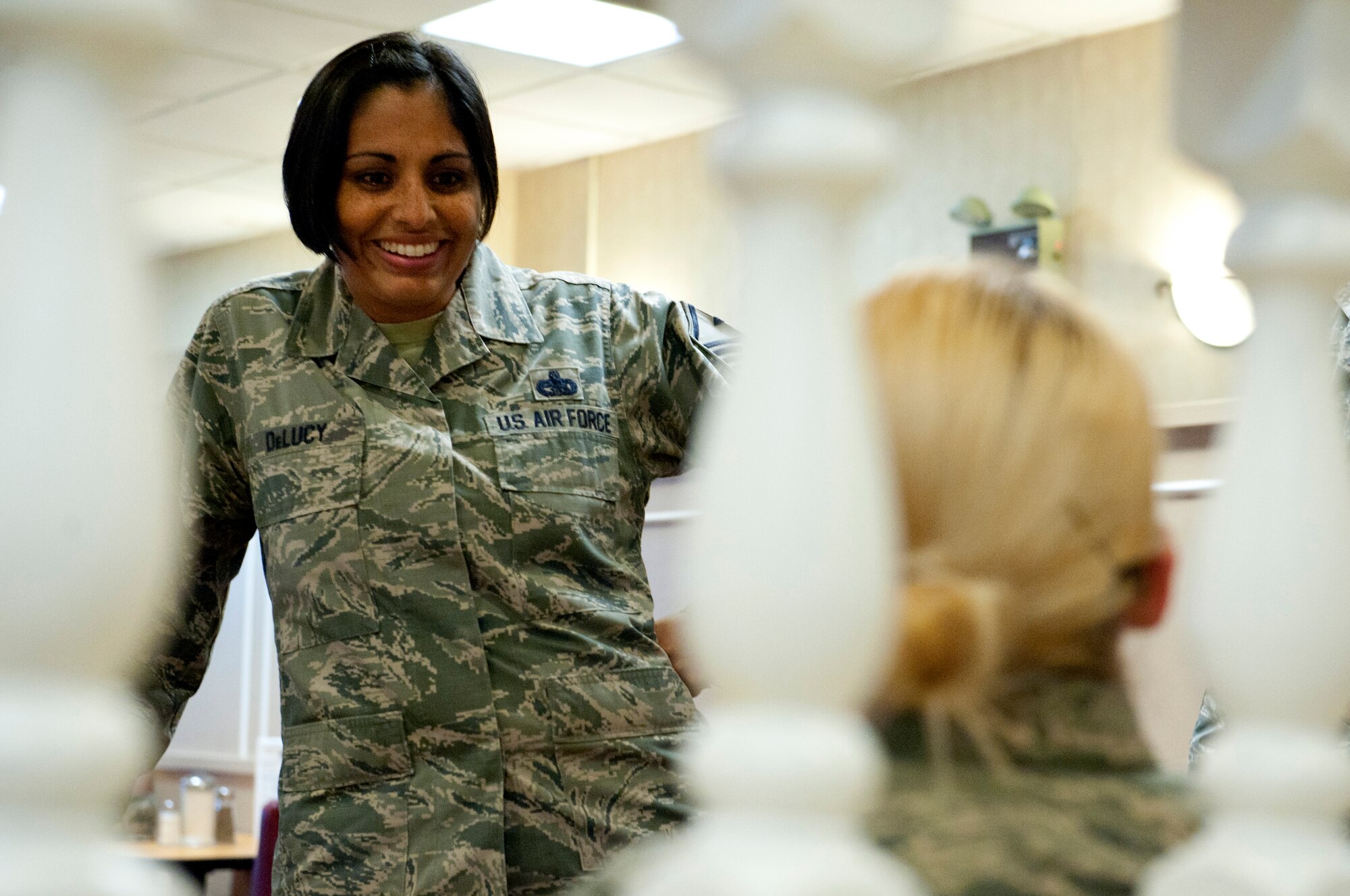 U.S. Air Force Master Sgt. Itxel DeLucy, 633rd Comptroller Squadron first sergeant, speaks with an Airman during a Random Acts of Kindness campaign at the Crossbow Dining Facility at Langley Air Force Base, Va., June 21, 2016. The campaign is part of the Langley First Sergeants Council “Operation Warmheart,”which aims to receive, manage and distribute charitable funds to the Joint Base Langley-Eustis community. (U.S. Air Force photo by Staff Sgt. R. Alex Durbin)