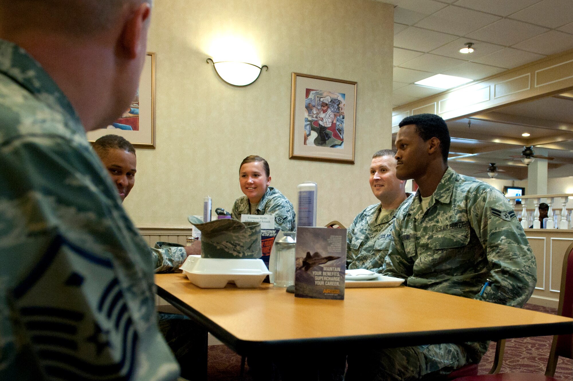 Members of the Langley First Sergeants Council interact with U.S. Air Force Airmen during a Random Acts of Kindness campaign at the Crossbow Dining Facility at Langley Air Force Base, Va., June 21, 2016. Throughout the day, the first sergeants handed out 100 $10 base exchange gift cards to junior-enlisted Airmen. (U.S. Air Force photo by Staff Sgt. R. Alex Durbin)