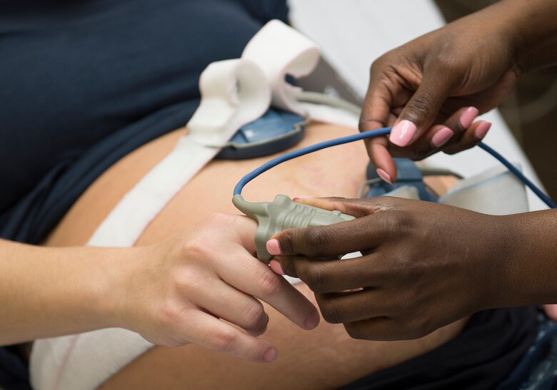 U.S. Air Force Staff Sgt. Tanshanika Thompson, 633rd Inpatient Squadron medical technician, takes the vitals of U.S. Navy Aviation Boatswain Handler Airman Leah Gunstream, during a triage visit at Langley Air Force Base, Va., June 27, 2016. The labor and delivery unit offers a room equipped with a system which allows deployed parents to be present during the delivery. (U.S. Air Force photo by Airman 1st Class Kaylee Dubois)