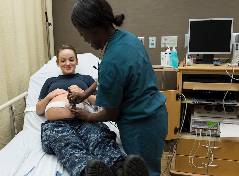 U.S. Air Force Staff Sgt. Tanshanika Thompson, 633rd Inpatient Squadron medical technician, performs a sonogram on U.S. Navy Aviation Boatswain Handler Airman Leah Gunstream, during a triage visit at Langley Air Force Base, Va., June 27, 2016. A neonatal intensive care unit, adjacent to the labor and delivery unit, ensures newborns with complications are provided prompt care. (U.S. Air Force photo by Airman 1st Class Kaylee Dubois)