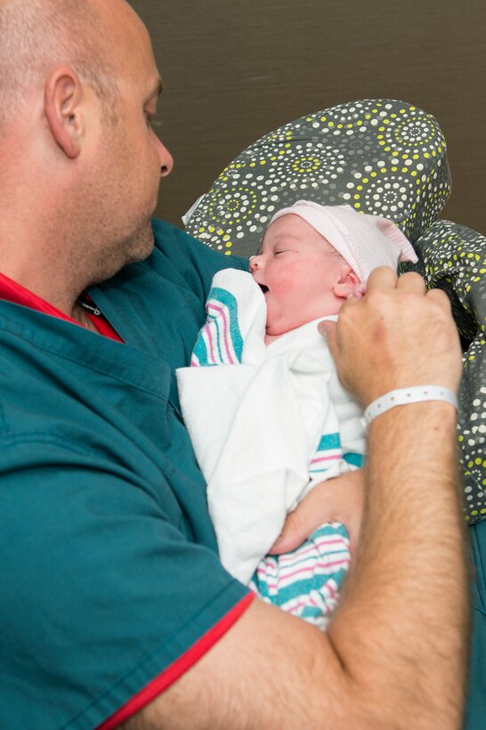 U.S. Air Force Master Sgt. Scott Hendrick, Air Combat Command Headquarters functional manager, cradles his daughter, Addalyn Grace Hendrick, who was recently born at the Langley Hospital labor and delivery unit at Langley Air Force Base, Va., June 27, 2016. The labor and delivery unit performs approximately 100 deliveries each month. (U.S. Air Force photo by Airman 1st Class Kaylee Dubois)