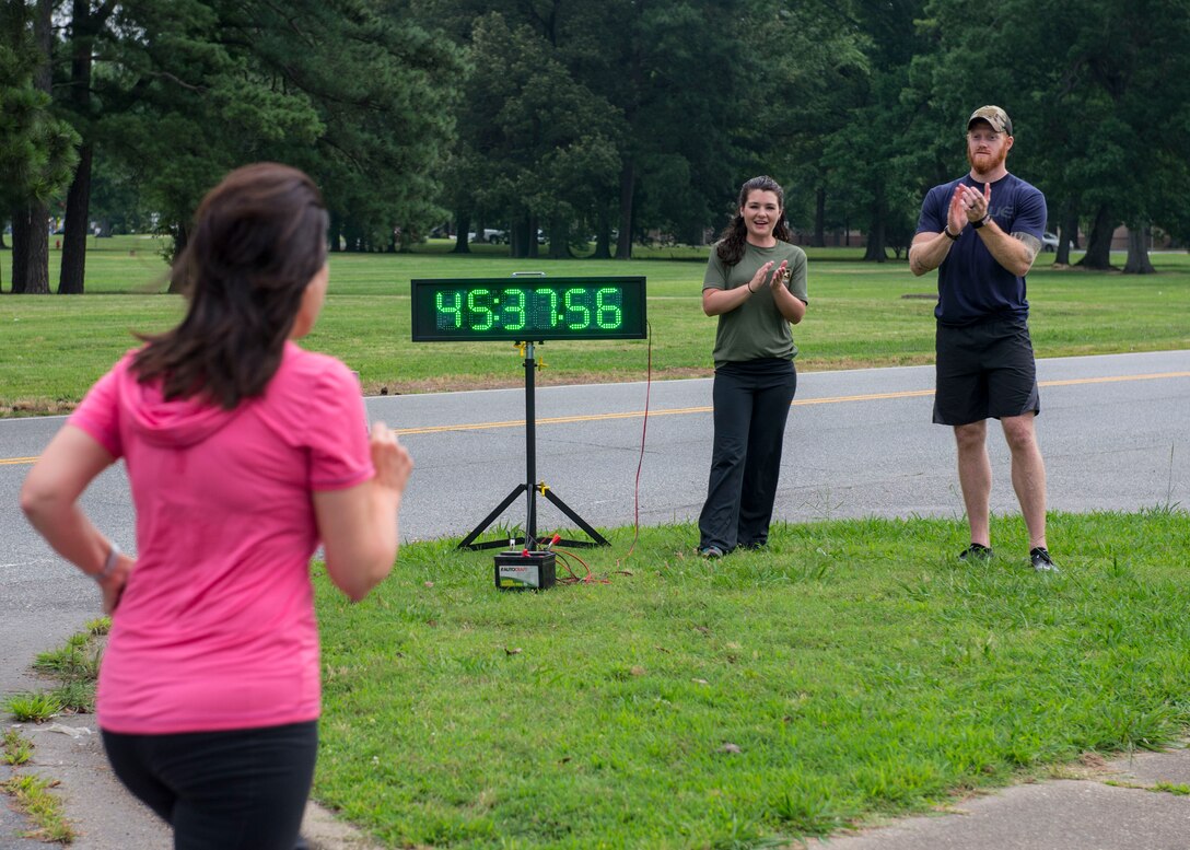 Kellie Jorgensen, 633rd Force Support Squadron fitness center director, and Jake Richmond, 633rd FSS fitness director, support a runner finishing the final 5K of the Civilian Commanders Cup Fitness Challenge at Fort Eustis, June 23, 2016. The challenge began with civilian employees, Service members and their families on Jan. 7 and finished June 23 with approximately 30 participants completing the challenge. (U.S. Air Force photo by Airman 1st Class Derek Seifert)