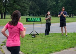 Kellie Jorgensen, 633rd Force Support Squadron fitness center director, and Jake Richmond, 633rd FSS fitness director, support a runner finishing the final 5K of the Civilian Commanders Cup Fitness Challenge at Fort Eustis, June 23, 2016. The challenge began with civilian employees, Service members and their families on Jan. 7 and finished June 23 with approximately 30 participants completing the challenge. (U.S. Air Force photo by Airman 1st Class Derek Seifert)