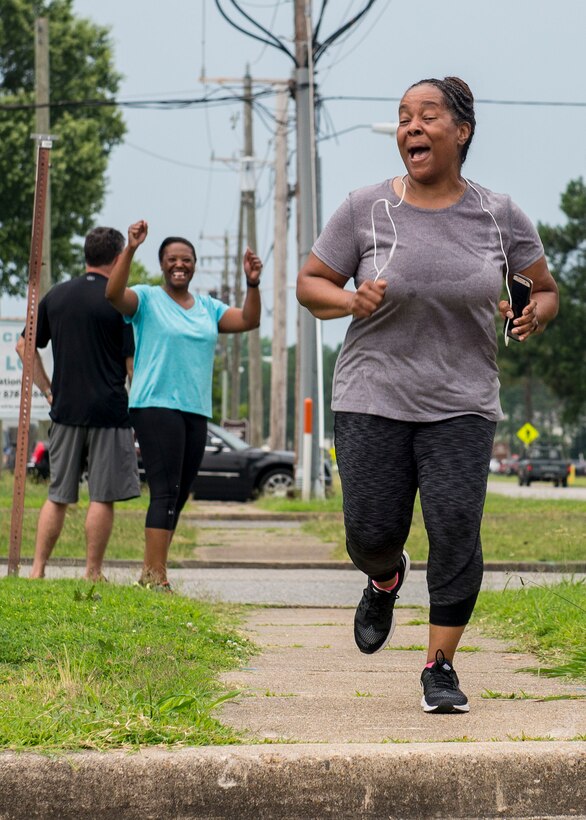 Toya Glover, McDonald Army Health Center licensed practical nurse, runs to the finish line during the final 5K run for the Civilian Commanders Cup Fitness Challenge at Fort Eustis, Va., June 23, 2016.  The Eustis Community Health Promotion Council started the initiative to promote civilian participation in the Army performance triad of getting quality sleep, engaging in activity and improving nutrition. (U.S. Air Force photo by Airman 1st Class Derek Seifert)